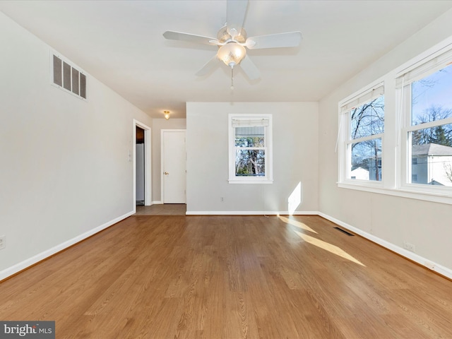 empty room featuring ceiling fan and light wood-type flooring