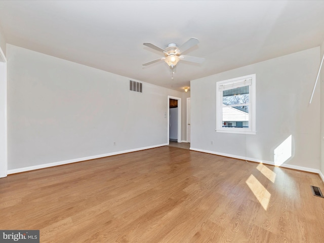 spare room featuring light hardwood / wood-style floors and ceiling fan