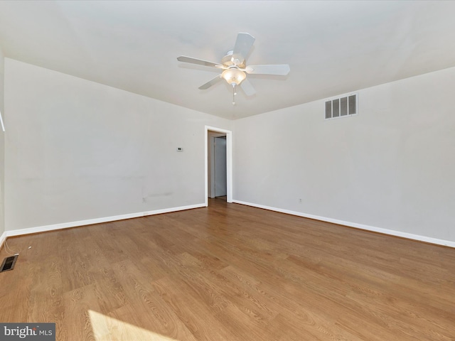 empty room featuring ceiling fan and light hardwood / wood-style flooring