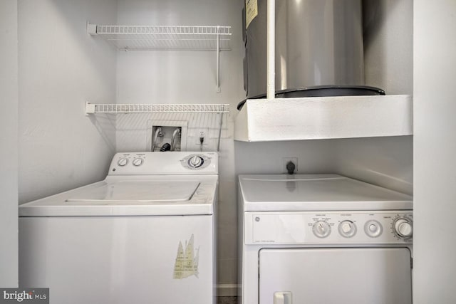 clothes washing area with washing machine and dryer