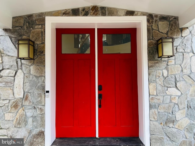 view of exterior entry featuring stone siding