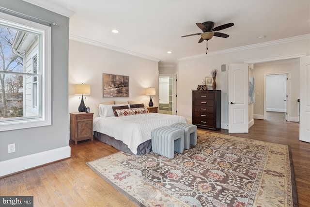 bedroom featuring crown molding, baseboards, wood finished floors, and recessed lighting