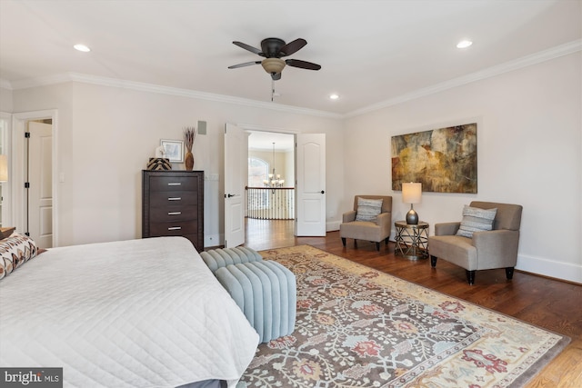 bedroom with dark wood-style floors, ornamental molding, recessed lighting, and baseboards