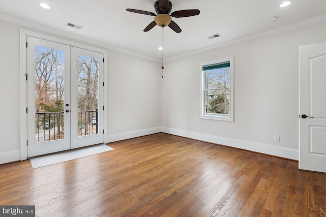 unfurnished room with visible vents, wood finished floors, french doors, and ornamental molding