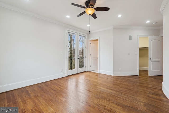 empty room featuring recessed lighting, wood finished floors, baseboards, french doors, and ornamental molding