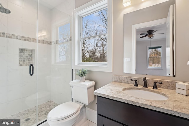 full bath featuring toilet, a shower stall, ceiling fan, and vanity