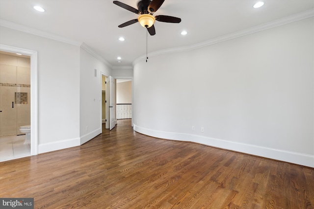 interior space with recessed lighting, wood finished floors, baseboards, ornamental molding, and ensuite bath