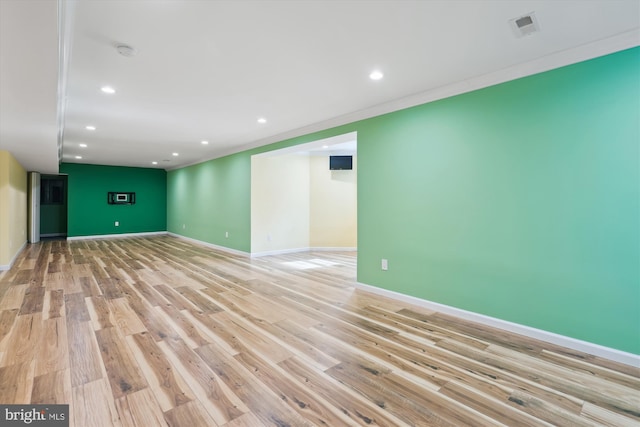 interior space featuring light wood-style flooring, recessed lighting, visible vents, baseboards, and ornamental molding