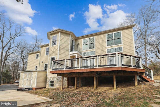 rear view of house featuring a deck