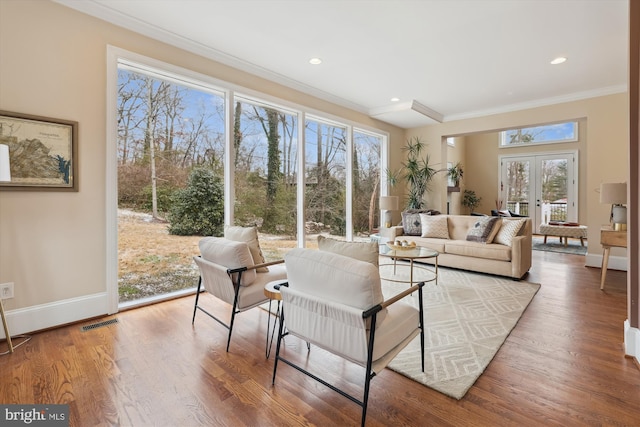 interior space featuring french doors, crown molding, recessed lighting, wood finished floors, and baseboards