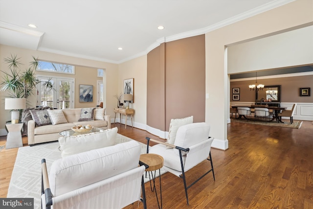 living area featuring crown molding, recessed lighting, an inviting chandelier, wood finished floors, and baseboards