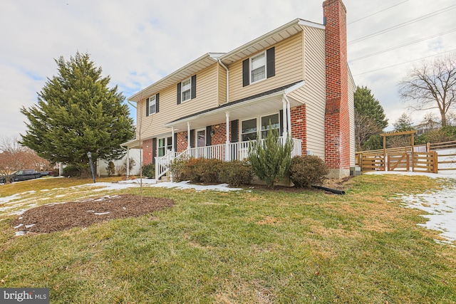 view of front facade with a front yard and a porch