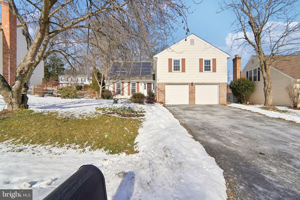 view of front of home featuring a garage and solar panels