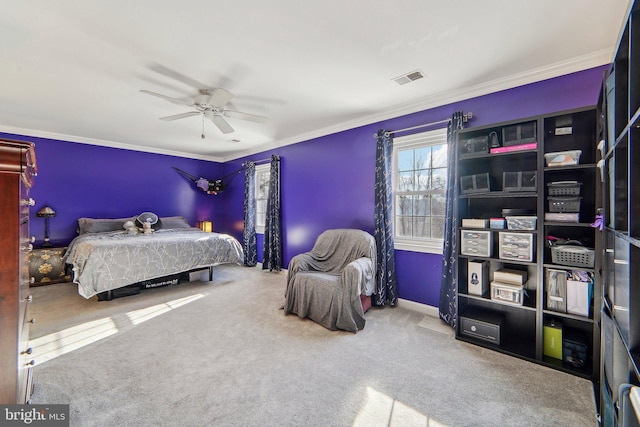 bedroom with crown molding, ceiling fan, and carpet floors