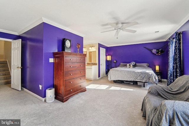 carpeted bedroom featuring ensuite bath, ornamental molding, and ceiling fan