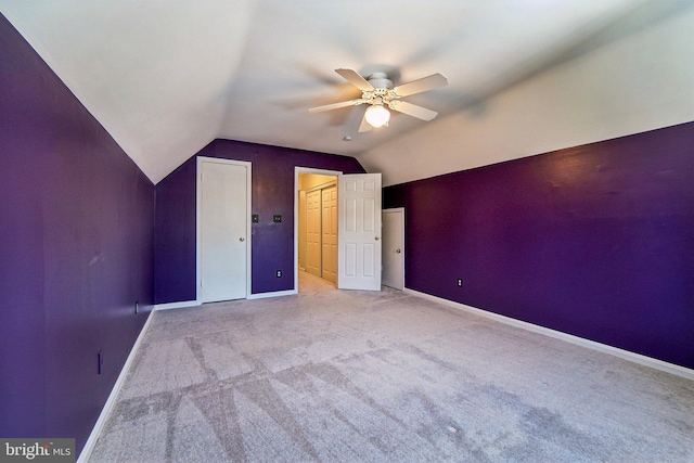 additional living space with ceiling fan, vaulted ceiling, and light carpet