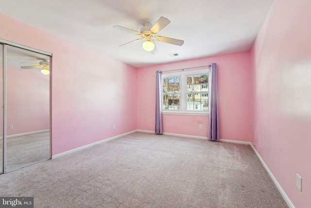 carpeted empty room with ceiling fan