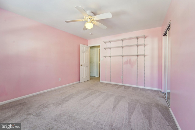 unfurnished bedroom featuring light colored carpet, ceiling fan, and a closet