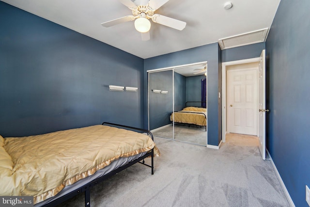 carpeted bedroom with a closet and ceiling fan