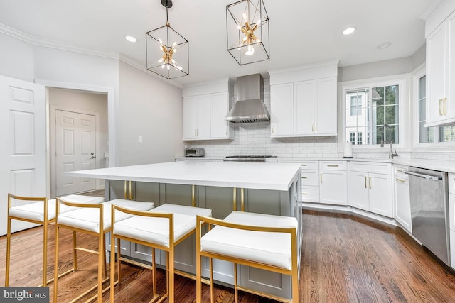 kitchen with white cabinetry, wall chimney range hood, stainless steel dishwasher, and a center island