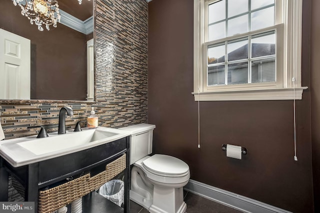 bathroom with vanity, ornamental molding, and toilet