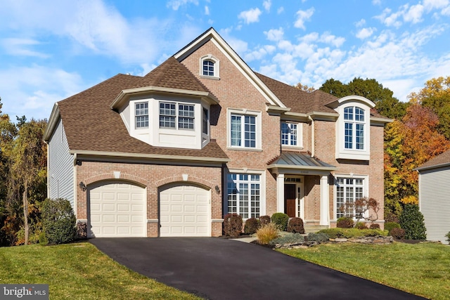 view of front facade featuring a garage and a front lawn