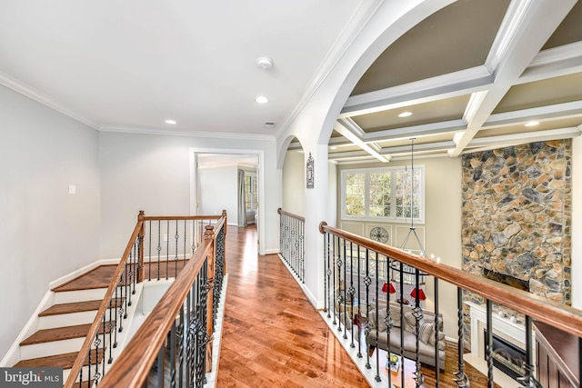 hall featuring beam ceiling, crown molding, coffered ceiling, and light hardwood / wood-style floors