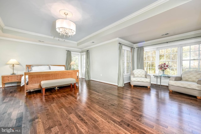 bedroom with a raised ceiling, ornamental molding, an inviting chandelier, and dark hardwood / wood-style flooring