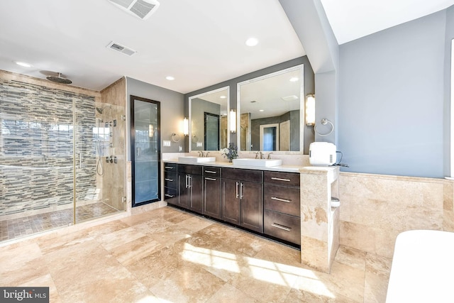 bathroom featuring vanity, tile walls, and an enclosed shower