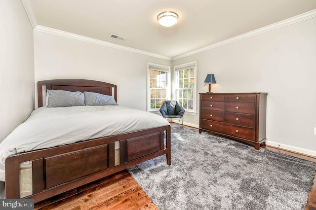 bedroom featuring dark wood-type flooring and ornamental molding