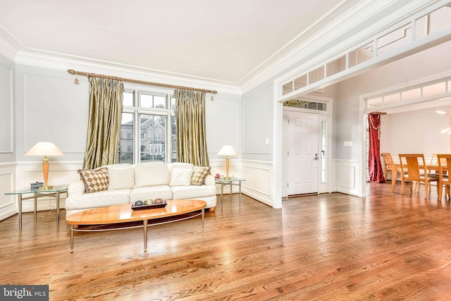 sitting room featuring hardwood / wood-style flooring and ornamental molding