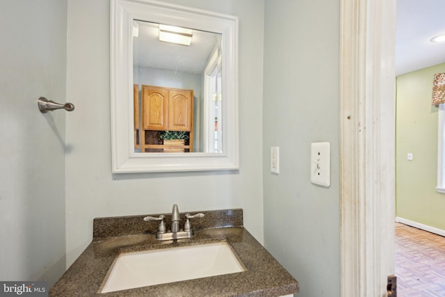 bathroom with parquet flooring and vanity