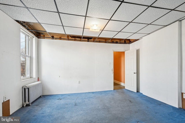 empty room featuring radiator and carpet