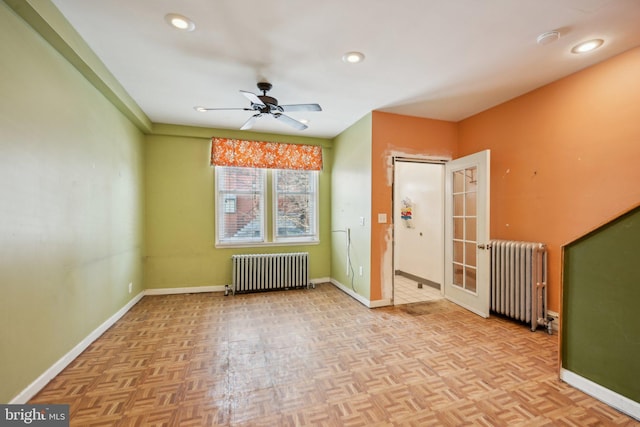 interior space featuring light parquet floors, radiator, and ceiling fan