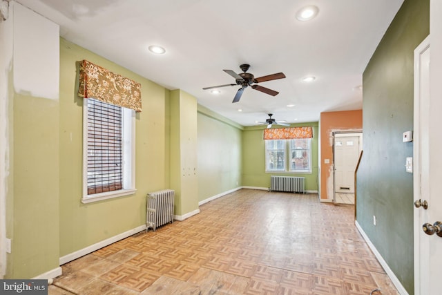 empty room featuring light parquet floors and radiator