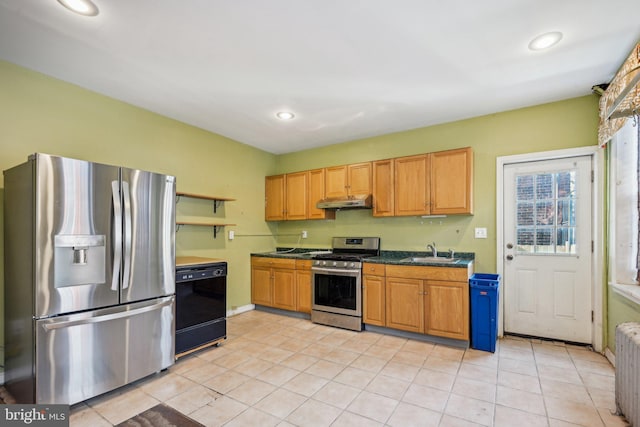 kitchen featuring sink, light tile patterned floors, radiator, and stainless steel appliances