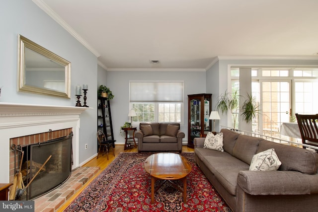 living room with ornamental molding and a fireplace