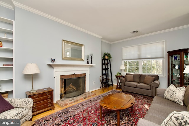 living room with crown molding, a fireplace, and light wood-type flooring