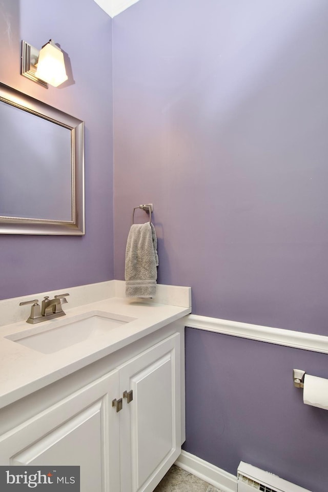 bathroom with vanity and baseboard heating