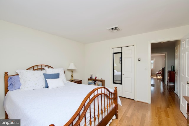 bedroom featuring a closet and light wood-type flooring