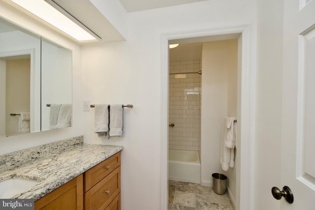 bathroom featuring vanity and tiled shower / bath combo