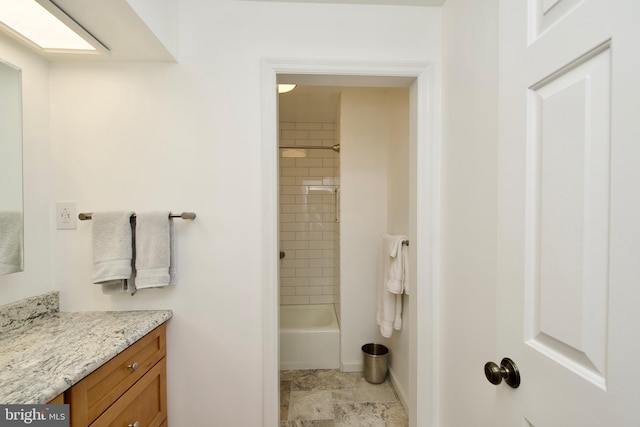 bathroom featuring vanity and tiled shower / bath combo