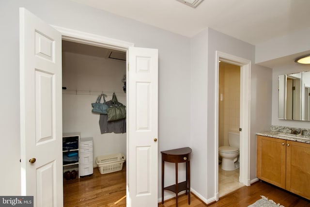 bathroom featuring hardwood / wood-style flooring, vanity, and toilet