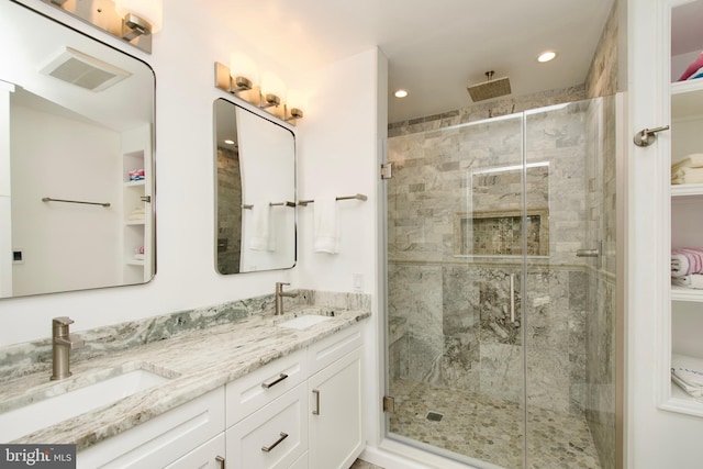 bathroom with an enclosed shower and vanity