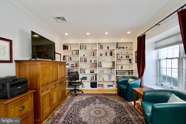 sitting room with ornamental molding and built in features