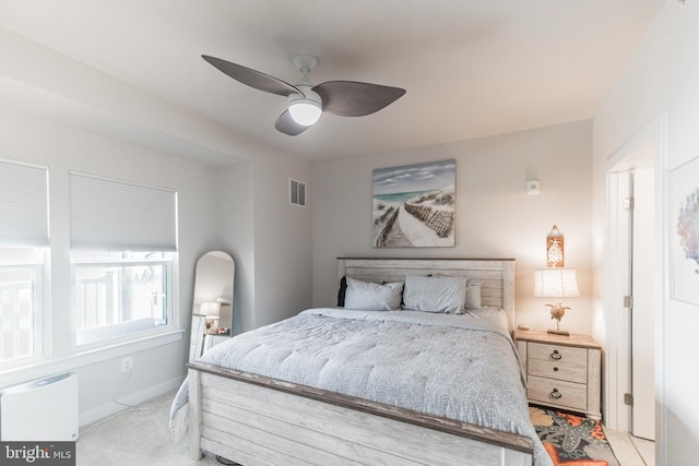 bedroom with light carpet and ceiling fan