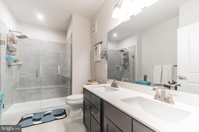 bathroom with toilet, vanity, and an enclosed shower