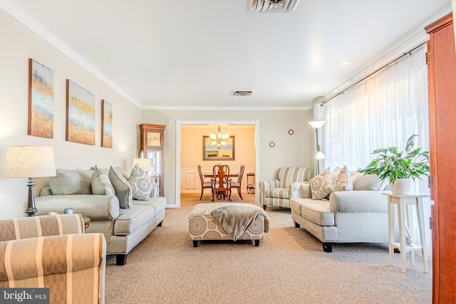 living room featuring an inviting chandelier, light colored carpet, and ornamental molding