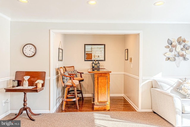 corridor with ornamental molding and carpet floors