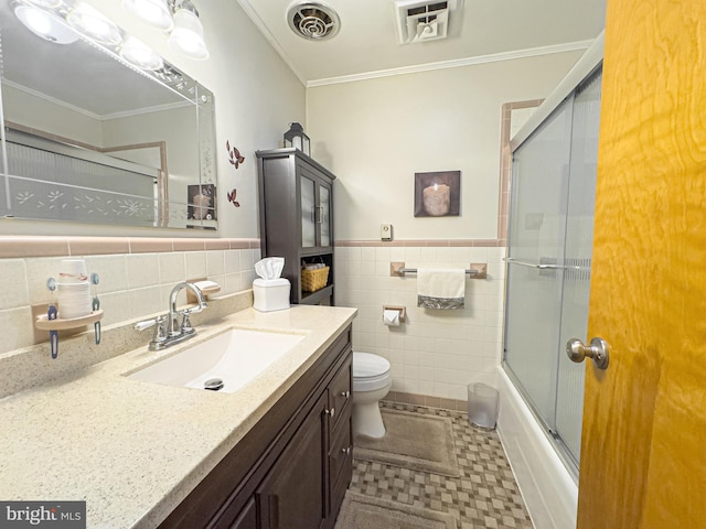 full bathroom featuring enclosed tub / shower combo, tile walls, toilet, and vanity